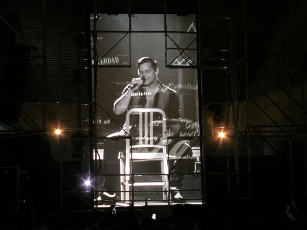 sexy ricky martin on stage on a chair